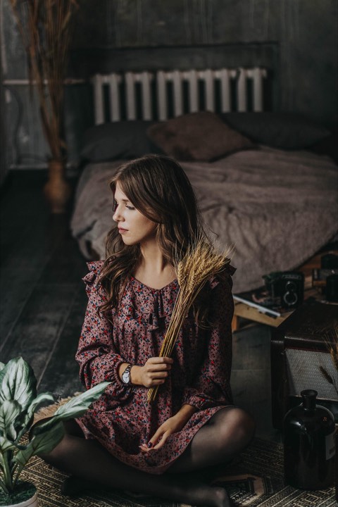 A woman in a dark, moody portrait