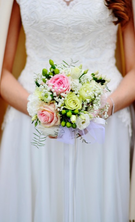 A bride holding a bouquet of roses